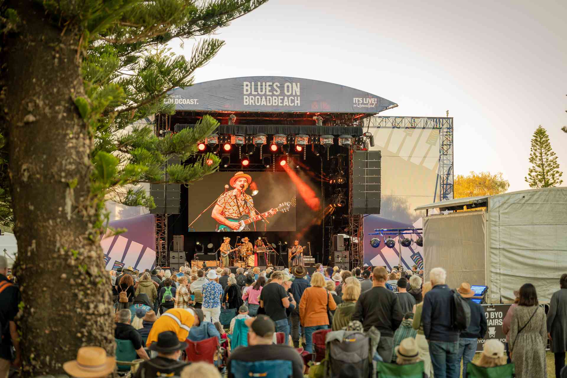 blues-on-broadbeach-2026-guide Crowd at a free Blues on Broadbeach outdoor stage at sunset, a short walk from Koko Broadbeach
