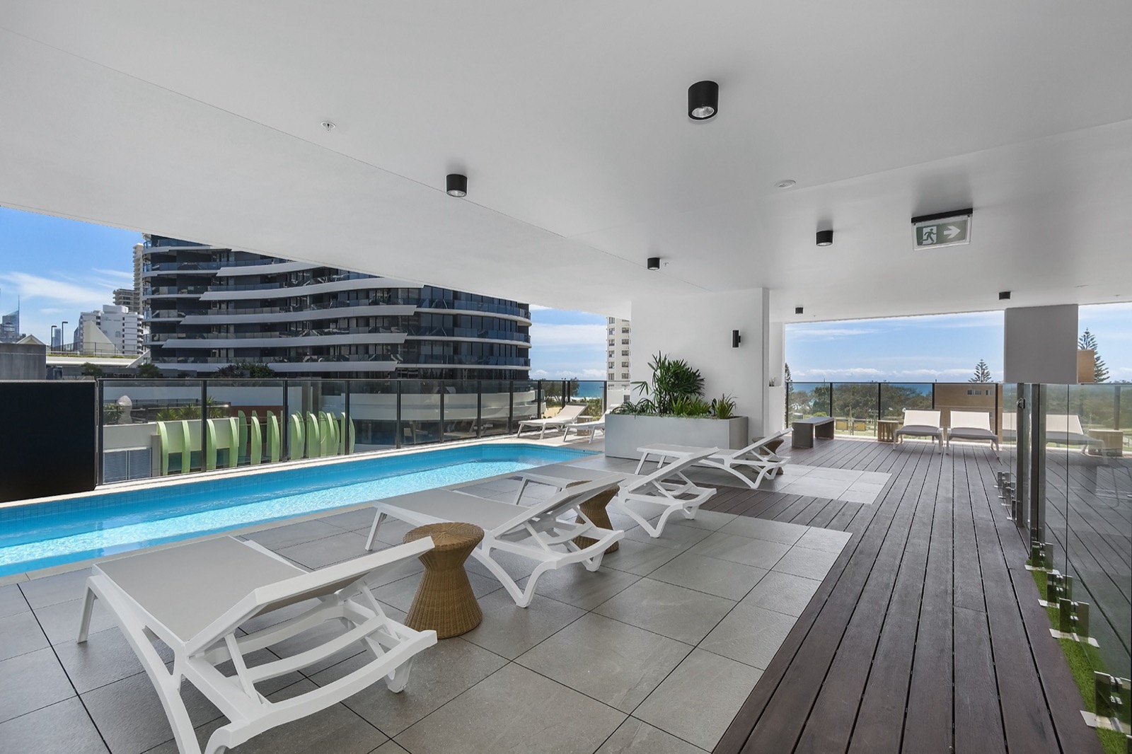 Level 5 pool deck at Koko Broadbeach with sun lounges and ocean views guests mention in reviews